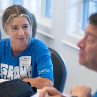 Woman at move-in looking over at gentleman sitting at her table